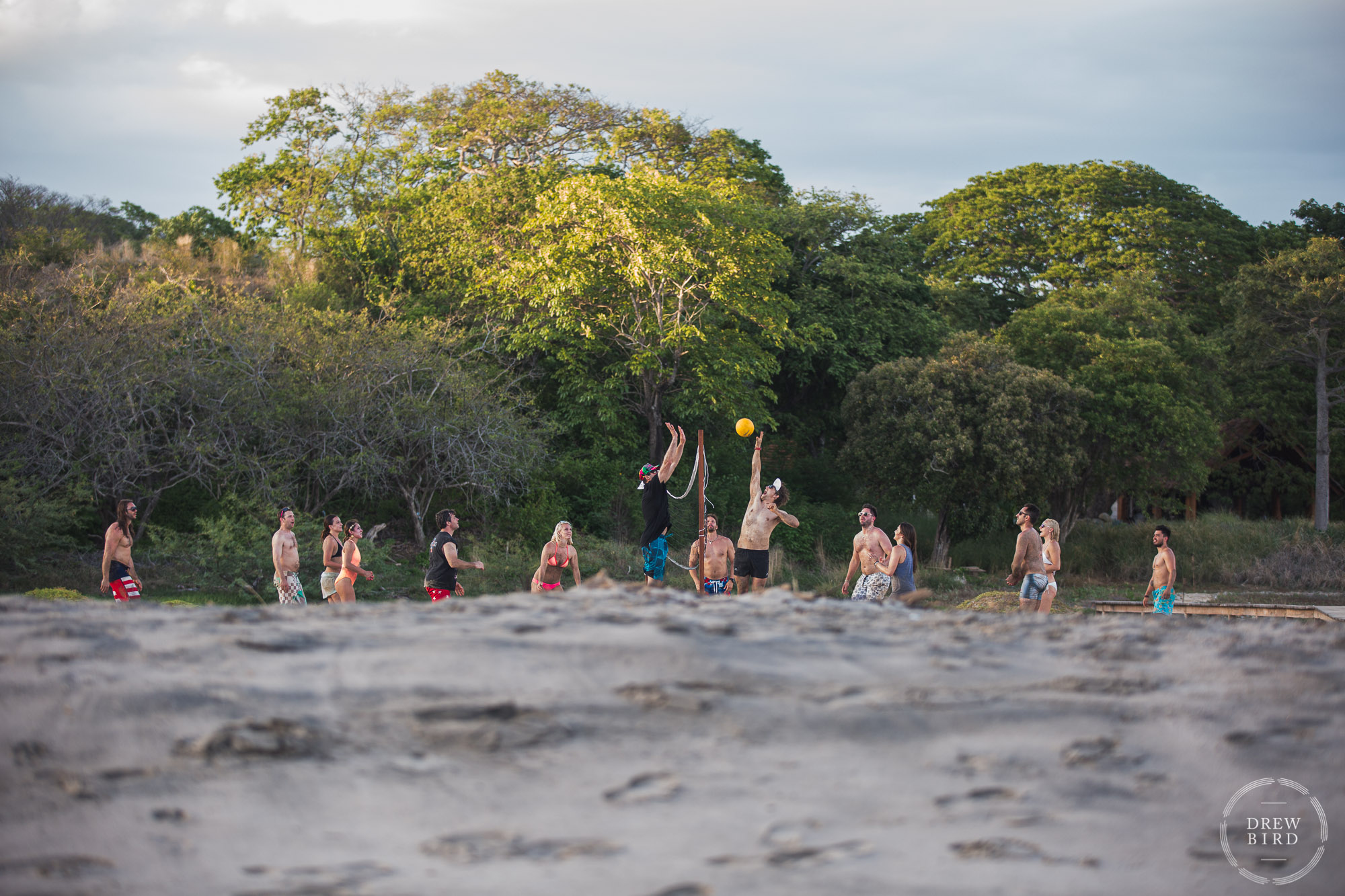 Beach volleyball game. Beach welcome party. Rancho Santana Nicaragua destination wedding photographer Drew Bird.