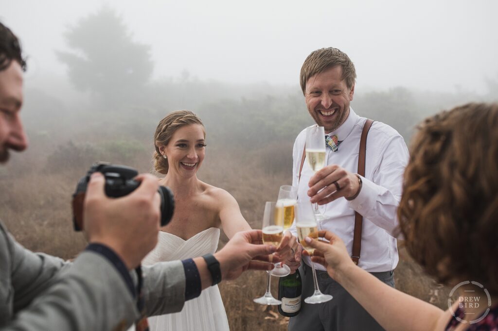 Bride and groom champagne toast at redwood forest micro wedding Marin California. Covid elopement wedding photographer Drew Bird.