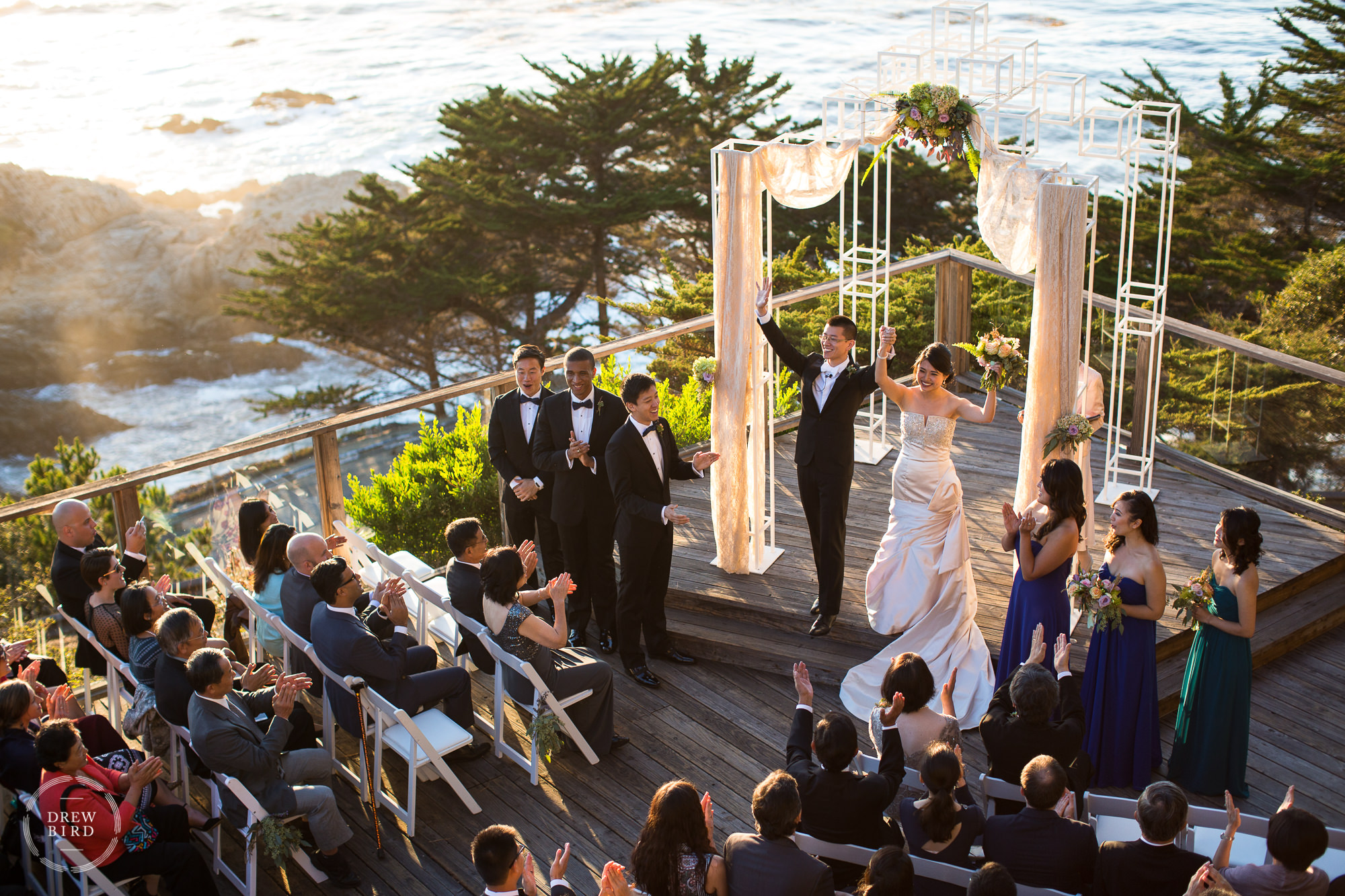 SF Bay Area wedding venues featuring Hyatt Carmel Highlands in Big Sur. Wedding couple celebrating during outdoor ceremony overlooking pacific ocean.