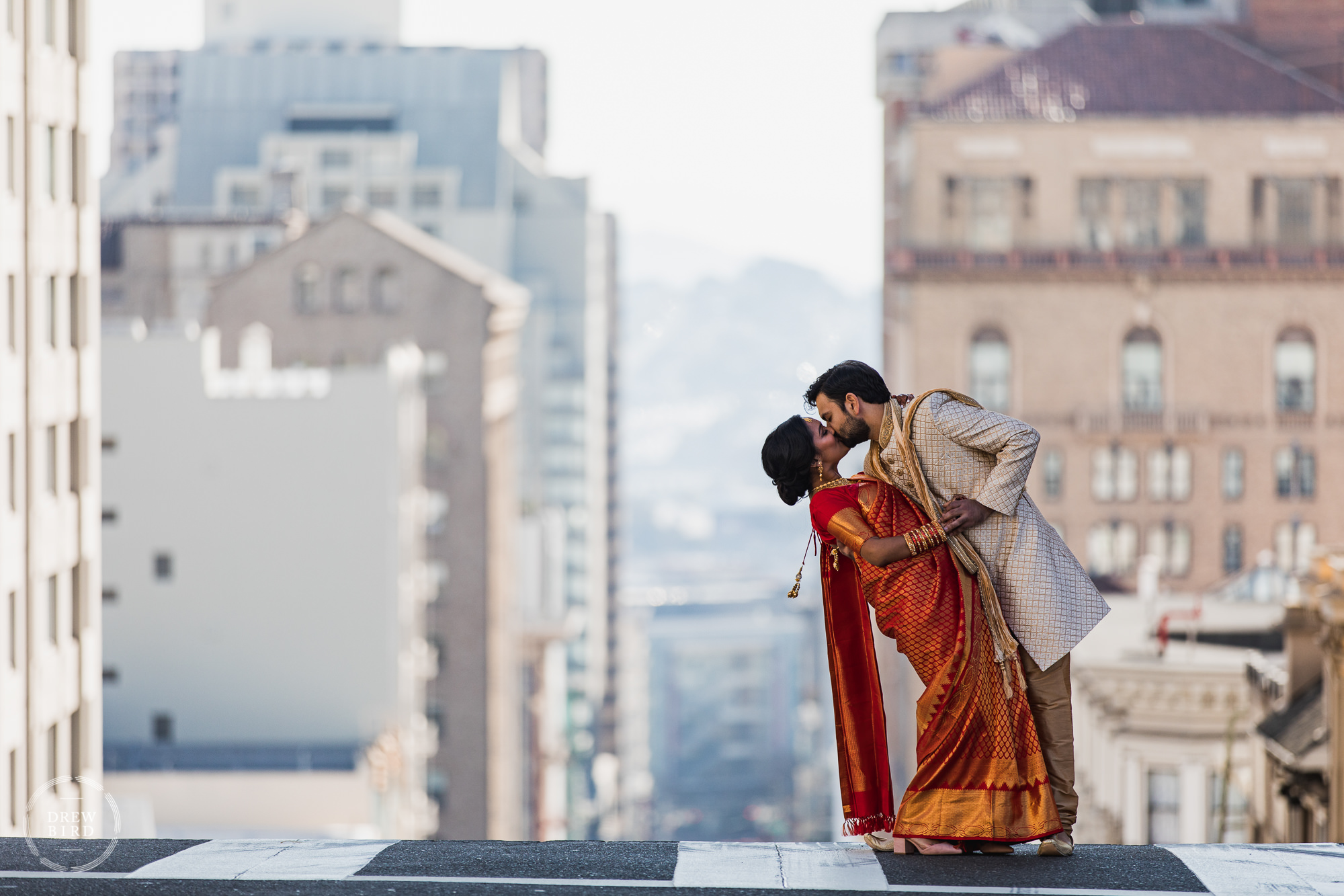 Fairmont Hotel wedding in San Francisco. Indian (Hindu) wedding couple kissing in the middle of the street.