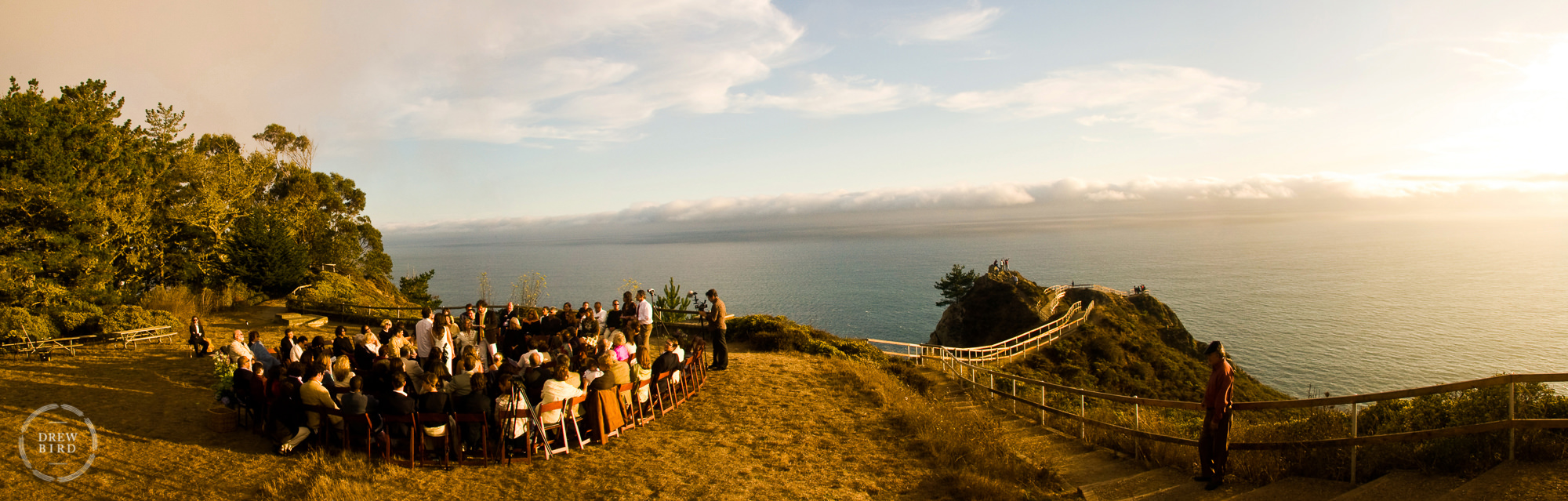 Muir Beach Overlook wedding ceremony at sunset on a cliff edge overlooking pacific ocean.