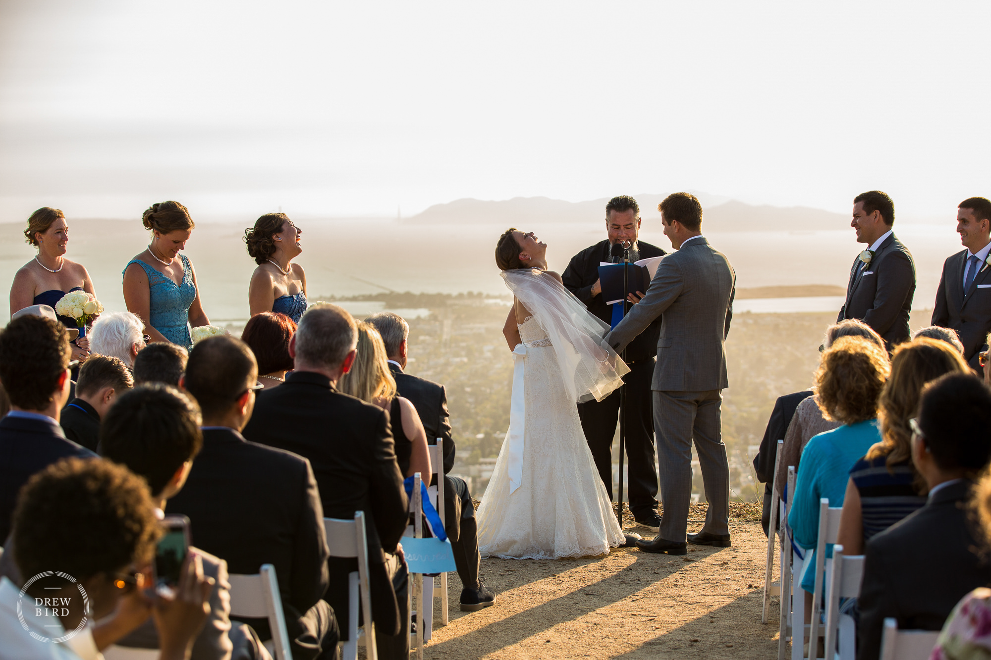 Wedding ceremony overlooking the San Francisco Bay at sunset. Lawrence Hall of Science wedding venue at UC Berkeley.