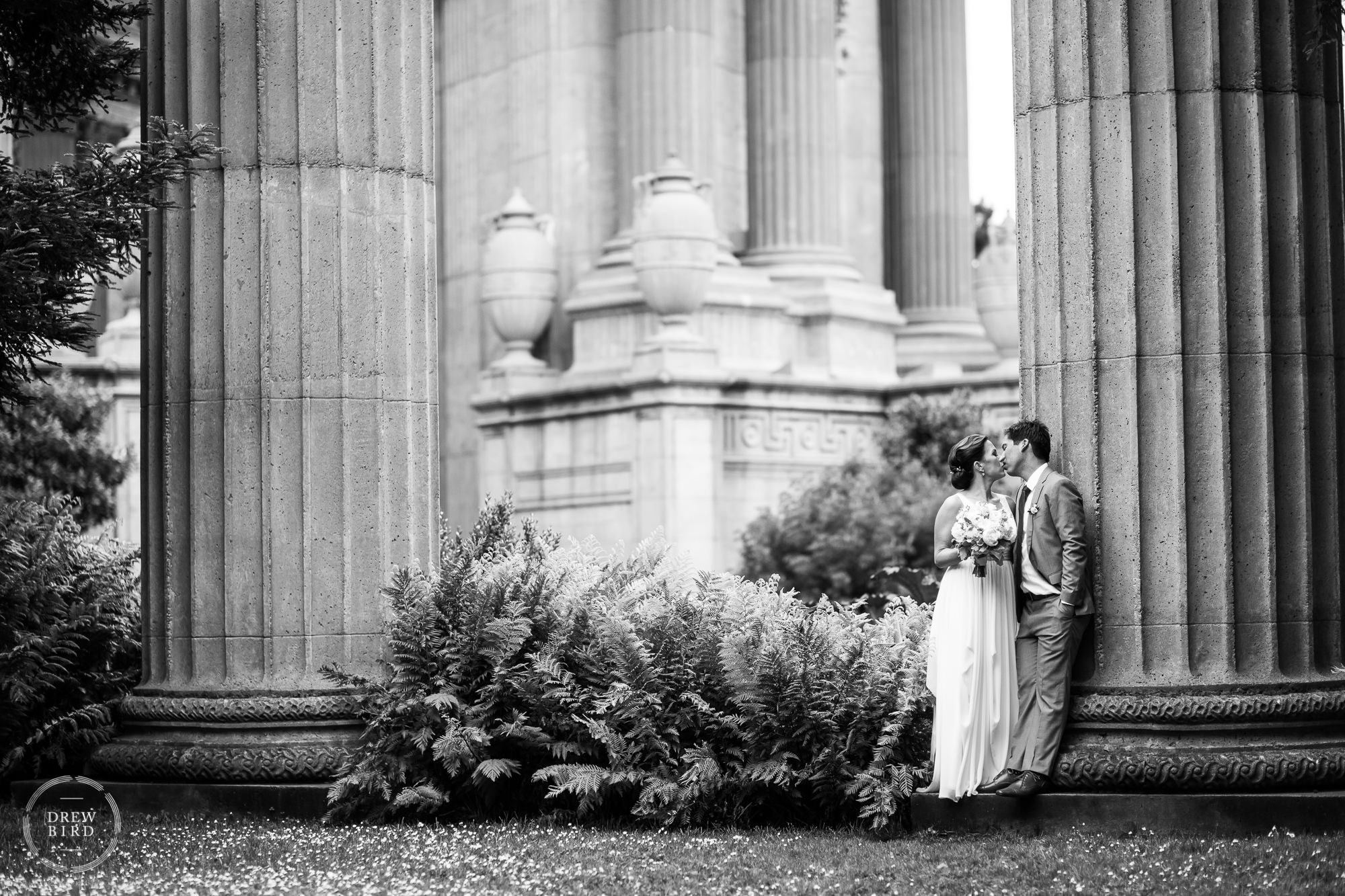 Bride and groom kissing at the palace of fine arts a wedding venue in San Francisco.
