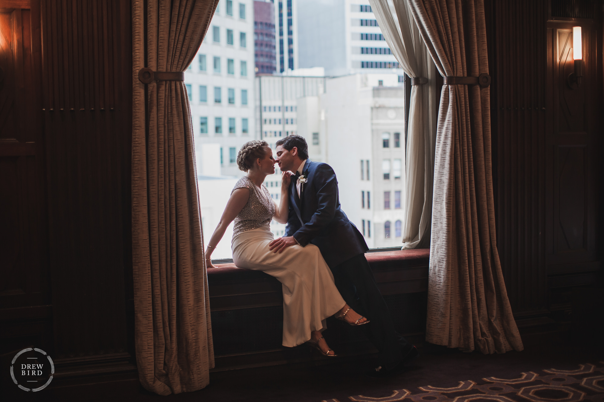 Bride and Groom sitting in a window frame. Julia Morgan Ballroom wedding venue in San Francisco.