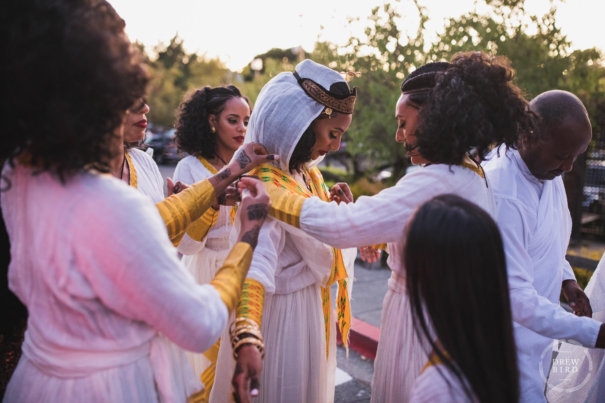Bride gets help with her traditional ethiopian wedding dress in Marin County near San Francisco by photographer Drew Bird.