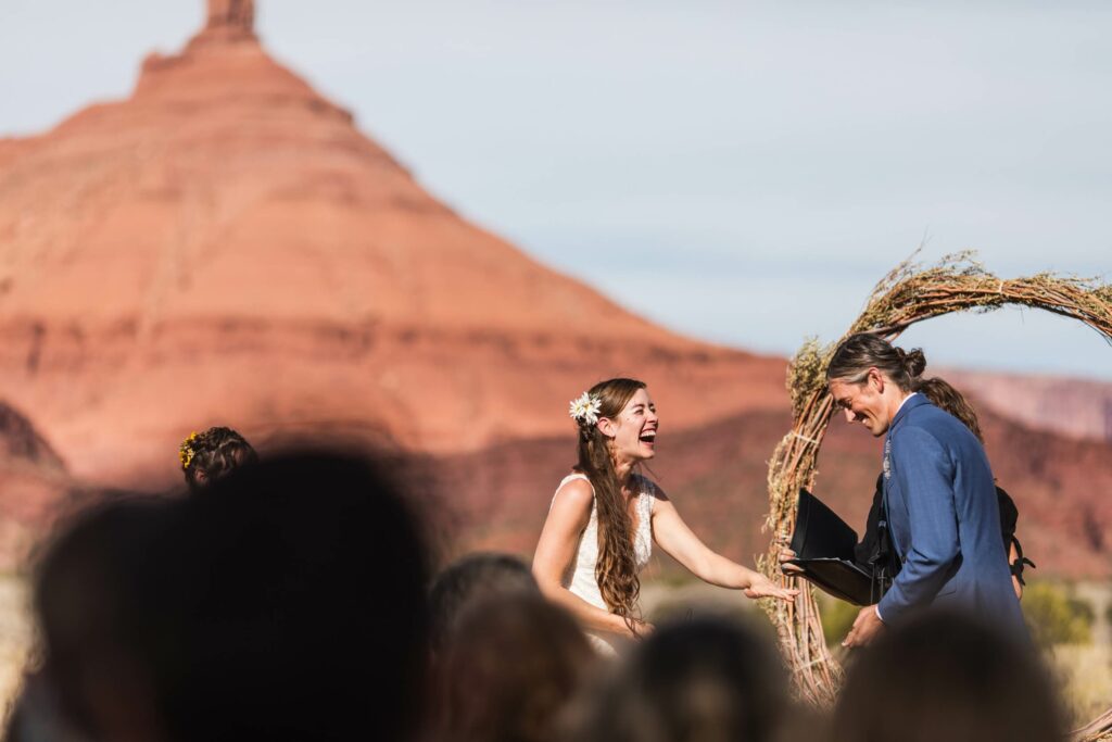 bride and groom exchange wedding vows in front of their watching guests