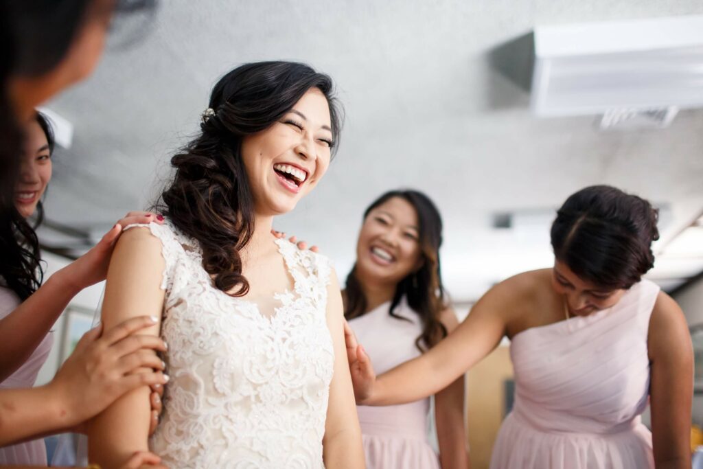 bridesmaids laughing together during bridal preparations