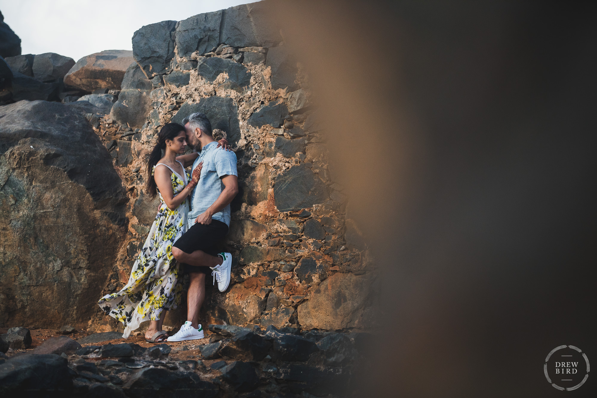 Hindu wedding couple lean against the walls of an ancient ruin in an intimate embrace. Destination wedding photography on Aruba.